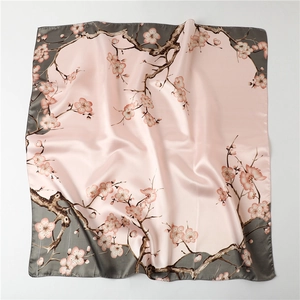 Detail of silk-like plum blossom scarf with elegant grey border and pink floral pattern
