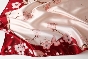 Detailed view of silky plum blossom scarf showing smooth texture and floral pattern