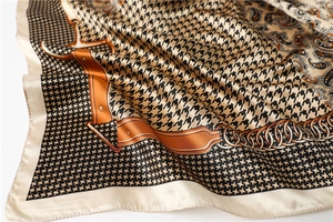 Detail of silk scarf with houndstooth, paisley patterns and golden chain motifs