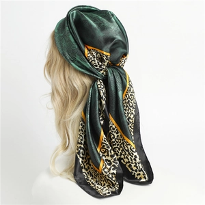 Elegant dark green satin scarf with yellow leopard print border and floral patterns