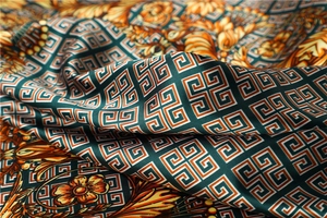 Detailed texture of dark green satin scarf with golden Greek key and Baroque floral patterns