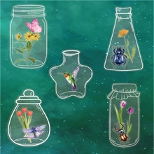 Detail of transparent jar stickers featuring colorful flowers and insects on a dark background
