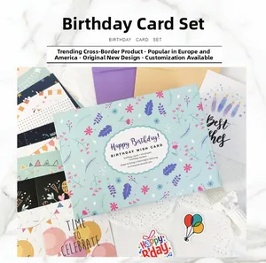 Flat lay of colorful DIY birthday card set with envelopes and floral designs on marble