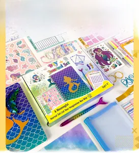 Close-up of DIY mermaid journal set with spiral notebook, mermaid pen, and stickers
