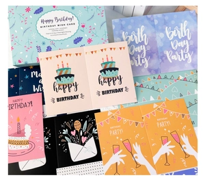 Flat lay of colorful DIY birthday card set with envelopes and assorted stickers
