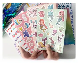 Close-up of DIY mermaid stickers set with various sea creatures and pre-cut adhesive pages