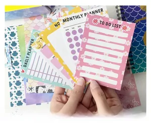 Close-up of pastel mermaid themed daily planner set and to-do lists for girls