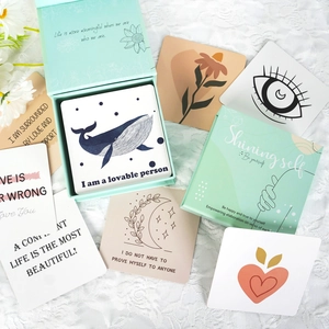 50 positive affirmation cards with abstract illustrations in a mint green display box