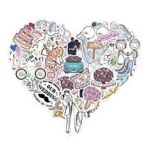 Heart-shaped arrangement of wedding theme stickers with cake, ring and floral patterns