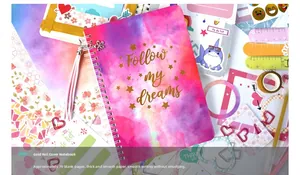 Macro view of pink journal set with gold foil lettering and decorative tassel