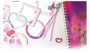 Close-up of 8 assorted pink and purple DIY scrapbooking frame stickers and decorative paper