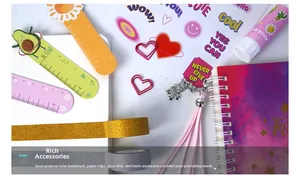 Detailed close-up of pink DIY journal set including glitter tape, clips, and stationery
