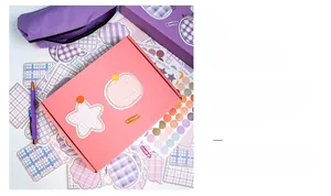 Flat lay of DIY stationery set showing pink gift box, purple stickers and pencil case