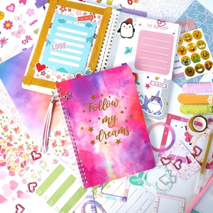 Pink DIY journal gift set featuring a spiral notebook, floral stickers, and stationery kit