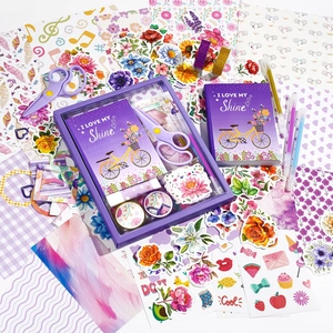 Purple DIY scrapbook kit with floral stickers, journal, and stationery in a gift box