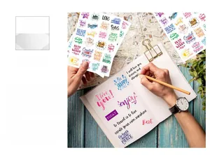 Close-up of colorful aesthetic inspirational quote stickers on a journal and stationery