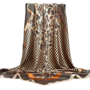 Luxurious satin scarf with paisley, houndstooth, and equestrian chain patterns in gold