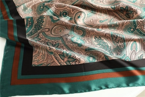 Detailed view of paisley silk scarf showing satin texture and intricate vintage patterns