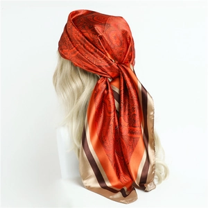Retro paisley square silk scarf worn as a stylish headwrap with orange and gold patterns