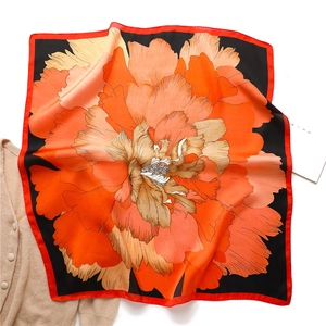 Texture détaillée du foulard en soie de 70 cm avec motif pivoine orange éclatant