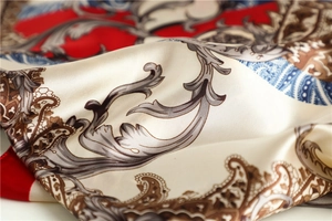 Macro shot of satin square scarf featuring baroque patterns and paisley floral details