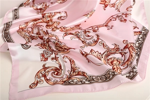 Detail of pink baroque silk scarf showing satin texture and fine rolled hem edges