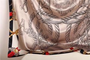 Detail of silk scarf showing glossy satin texture and vintage equestrian print