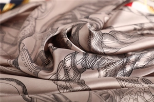 Detail of silk satin scarf showing champagne gold fabric with vintage rope pattern