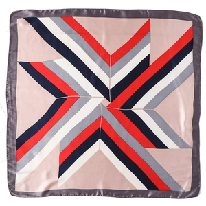 Close-up of geometric star pattern on pink satin scarf with navy and red stripes
