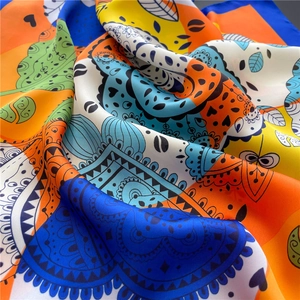 Detailed view of colorful abstract silk scarf with heart patterns and soft satin texture