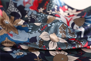 Close-up of vintage floral satin scarf fabric with silk texture and elegant drape