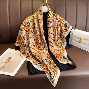 Detailed view of large vintage mandala print square scarf in orange and beige tones