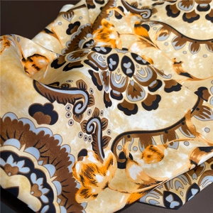 Detail of vintage paisley print silk scarf with satin finish and elegant folds