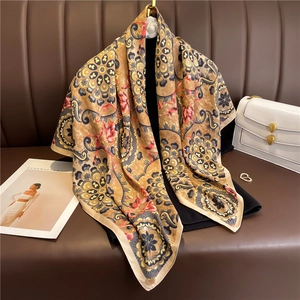 Detail of bohemian silk-feel scarf with vintage mandala and red floral print