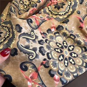 Detailed view of luxury vintage mandala print scarf showing silk texture and golden drape