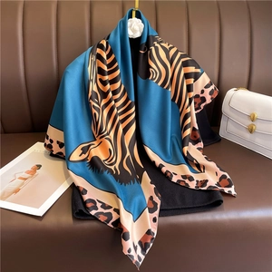 Blue leopard and zebra print silk scarf with satin finish draped on black garment