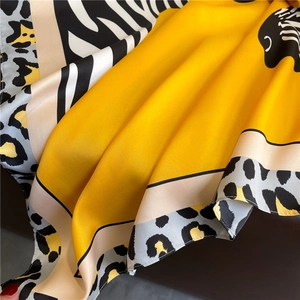 Macro shot of silk satin leopard scarf with zebra pattern and bright yellow accents