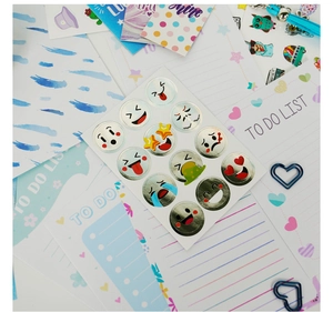 Close-up of blue DIY journal set including emoji stickers, to-do lists and cute accessories