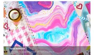 Detailed flat lay of a colorful marble diary with 70 blank sheets and scrapbooking tools