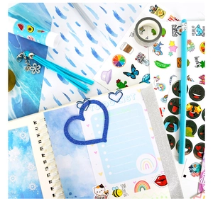 Detailed flat lay of blue DIY journal set including notebook, stickers and stationery
