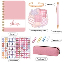Flat lay of pink DIY journal set with notebook, pen, bracelet and stationery accessories