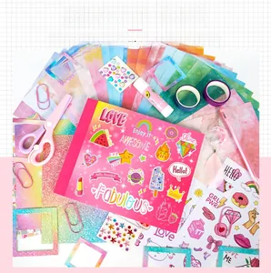 Flat lay of pink DIY journal set with glitter stickers, washi tape, and stationery tools