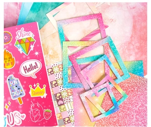 Detail view of pink glitter frames and colorful cartoon stickers for DIY journal set
