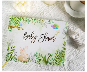 Detail of baby shower guest book with watercolor rabbit and green leaf cover design
