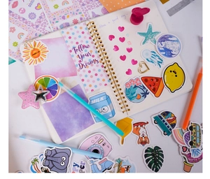 Detail of colorful cartoon stickers and DIY scrapbook pages with creative stationery