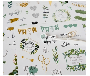 Detail of heart-themed wedding stickers with Happy Life and Love calligraphy art