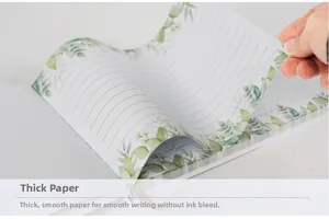 Close-up of thick smooth paper in guest book with leaf patterns and ink-proof quality