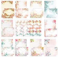 Flat lay of watercolor floral stationery set with matching envelopes and sticker seals