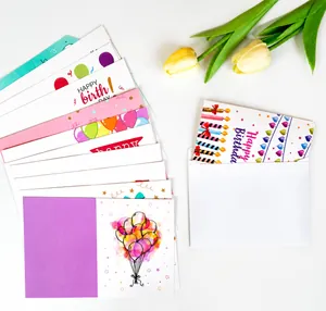 Flat lay of colorful birthday card set with various festive patterns and white envelopes