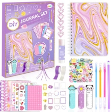 Flat lay of pink DIY journal set with marble notebook stickers pens and glue stick